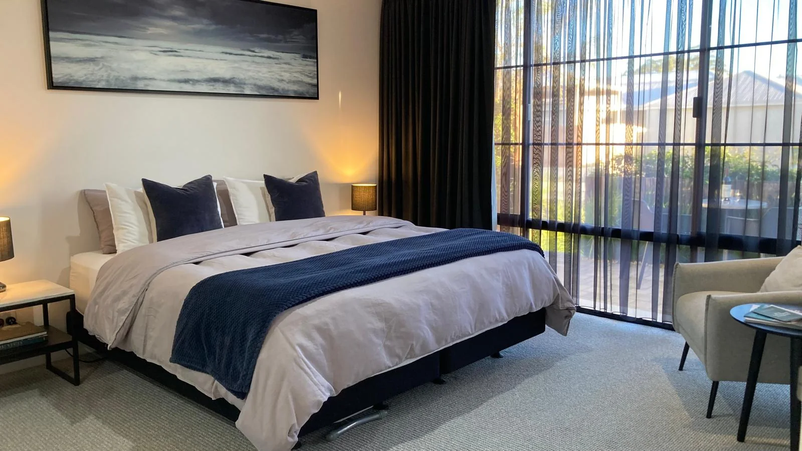 King bed with blue and charcoal linen in the BRiX suite
