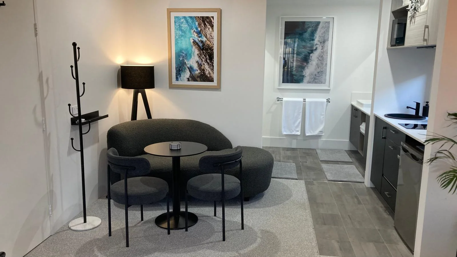 BRiX living area with curved sofa and adjoining kitchenette