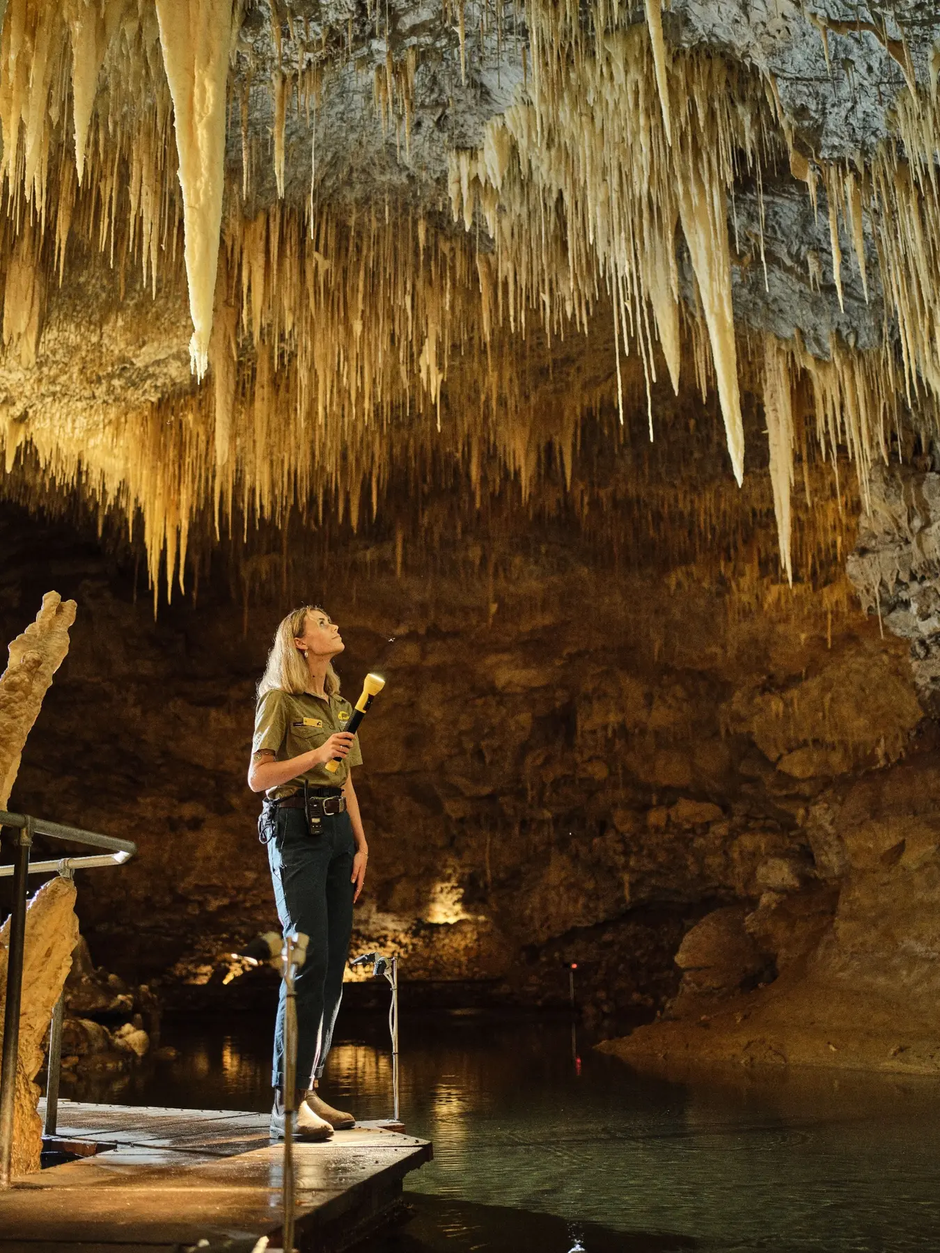 Tour guide beneath stalactites at Lake Cave in the Margaret River region